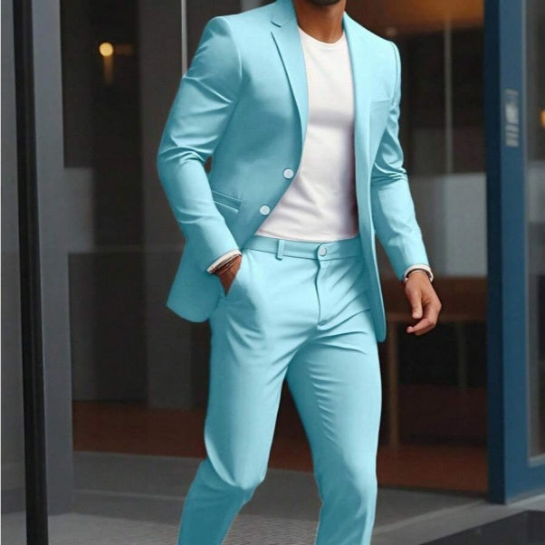 Person wearing a light blue suit with a white shirt in an indoor setting.
