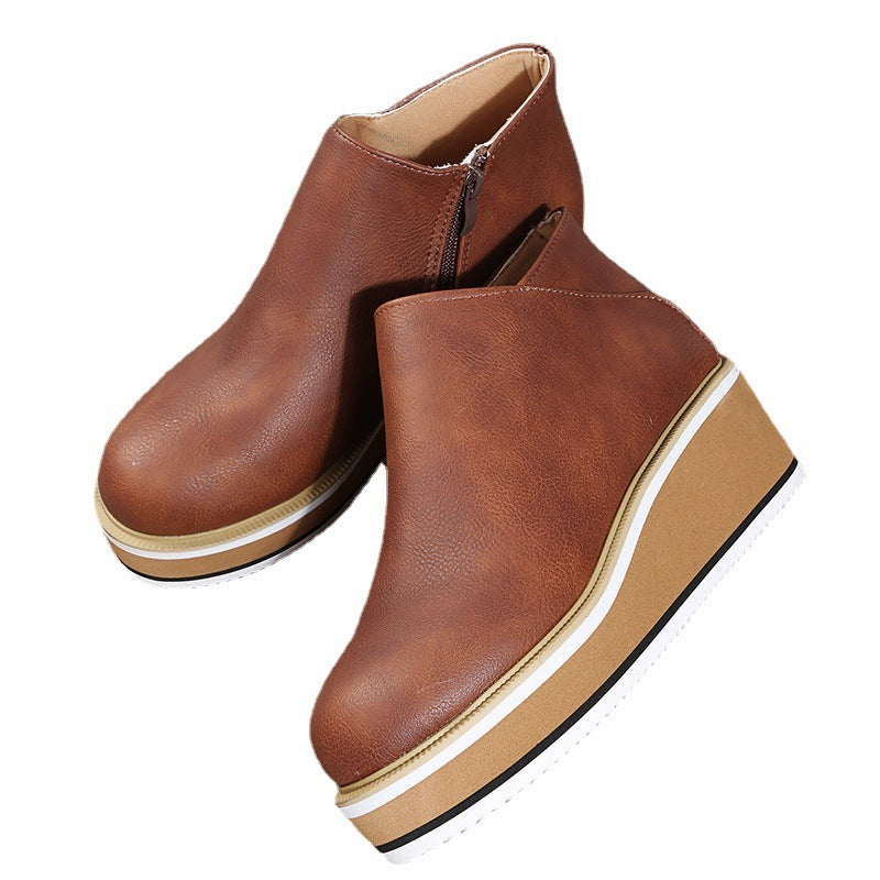 Brown leather ankle boots with a platform sole on a white background